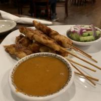 Chicken Satay · Chicken skewers grilled. Served with peanut sauce and a cucumber salad.