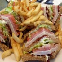 Club Sandwich Lunch · Turkey, ham, bacon, lettuce, and tomatoes stacked on toasted wheat.