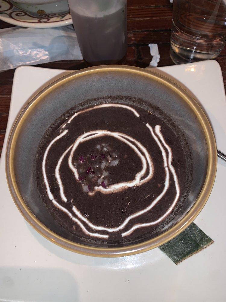 Black Bean Soup · Rich and slow-simmered flavors, red onions,
sour cream