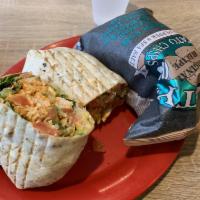 Grilled Buffalo Chicken Caesar Wrap · Herb and garlic wrap, crisp romaine lettuce, croutons, tomatoes, Parmesan cheese and Caesar ...