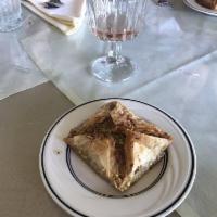 Baklava · Thin layers of filo dough with crushed walnuts, special sweet syrup, and topped off lightly ...