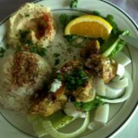 Shish Tawouk Curry · Curried lemon and garlic chicken pieces cooked to perfection, served on a bed of onions, wit...