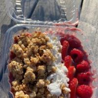 Berry Me Bowl · Acai berries topped with tart raspberries, thinly sliced strawberries,  shredded coconut, gr...