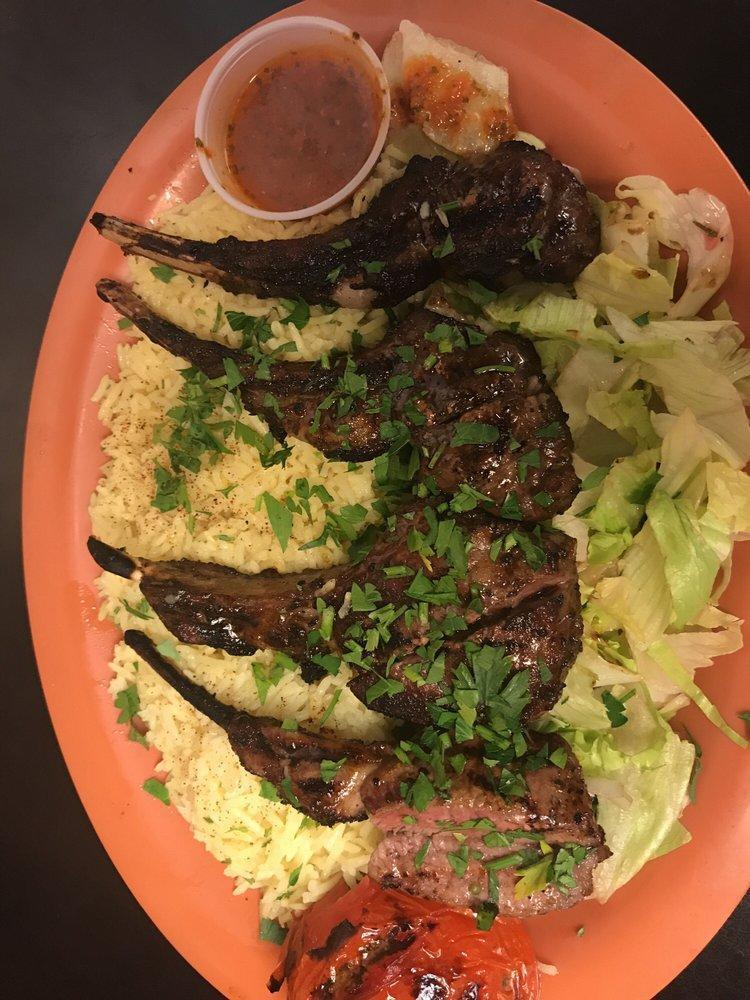 Lamb Chops · Rack of lamb chops marinated and grilled to perfection. Includes a house salad and Italian dressing, a serving of hummus and a side of rice.