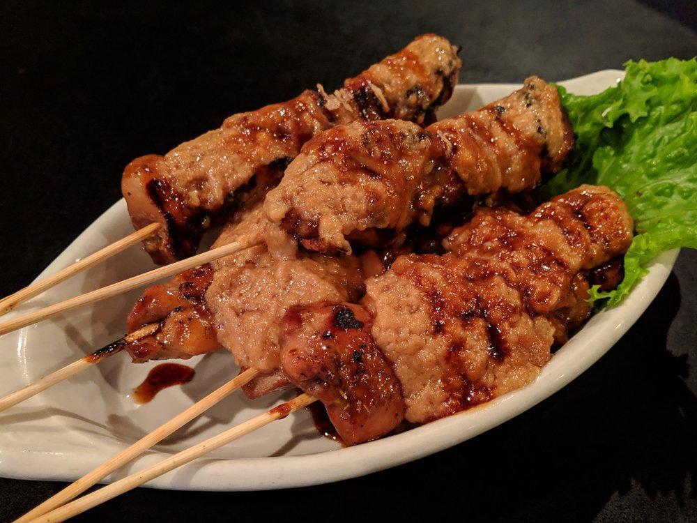 Sate Ayam · Grilled marinated chicken skewers, topped with homemade peanut sauce and sweet soy sauce.