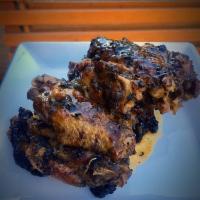 Jerk Wings · Cooked wing of a chicken coated in sauce or seasoning.