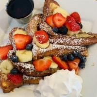 Combo Fruit French Toast · 4 piece tasty slices of French toast topped with fresh strawberries, bananas, blueberries, p...