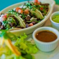 3 Street Tacos · Served on small corn tortillas, filled with fresh homemade guacamole, salsa, cilantro and on...