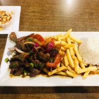 Lomo Saltado · Beef. A masterpiece of sauteed tender beef pieces, with onions, tomatoes, french fries, spri...