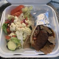 Famous Gyro Wrap · A perfect blend of lamb, pork, and beef piled on an pita with lettuce, tomato, onions and tz...