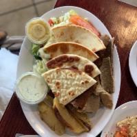 Gyro Platter · A blend of sliced beef and lamb. Served open faced with Greek salad, pita, and choice of Gre...
