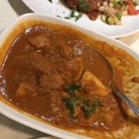 Chicken Vindaloo · Chicken marinated with vinegar, green peppers and spices then cooked with potatoes in a fier...