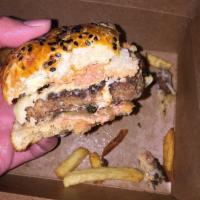The Garrison Burger · Happy Valley beef burger, housemade milk bun, raclette cheese, confit onions, burger sauce, ...