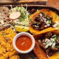 Tacos Al Carbon · Served with rice and beans. Three corn tacos with carne arrachera steak. The tortillas are d...