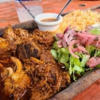 Cochinita Pibil · Served with rice, beans and hand made tortillas. Traditional Mayan dish is slow cooked marin...