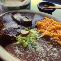 Mole Poblano · Served with rice, beans and hand-made tortillas. Made with a variety of chilis, such as chil...