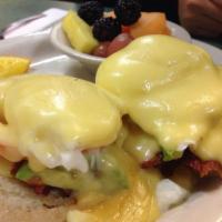 Eggs Benedict · 2 poached eggs and ham on an English muffin topped with hollandaise sauce served with fresh ...