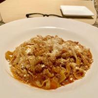 Fettuccine Bolognese · Fresh long flat pasta tossed in beef ragu sauce.