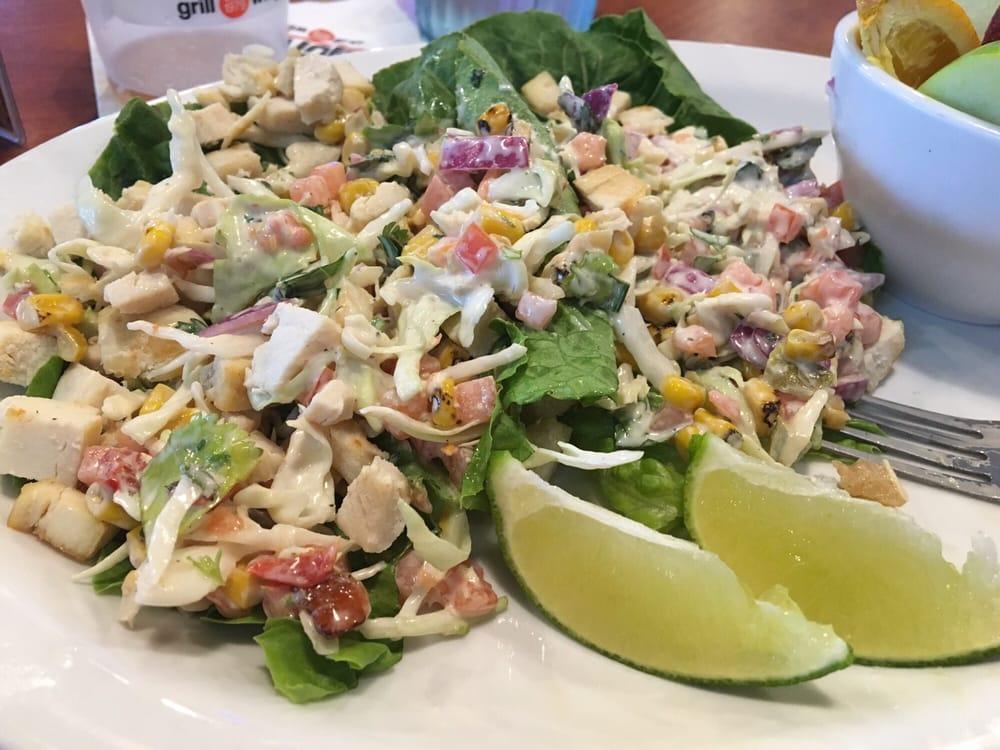 Chicken Lettuce Wraps · A crisp combination of grilled chicken, cabbage, carrots, bell peppers, tomatoes, red onion, yellow onion, corn, cilantro, salt & vinegar seasoning, and basil topped with our low-calorie ranch vinaigrette dressing. Served on top of fresh romaine lettuce leaves.