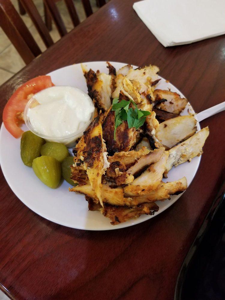 Chicken Shawarma · Boneless chicken, marinated in vinegar, yogurt, house spices, ground cardamom and served with pickles and tomoatoes