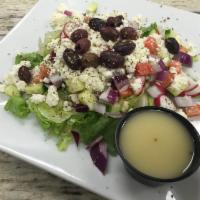 Greek Salad · Chopped salad topped with feta cheese and Kalamata olives served with house lemon herb vinai...
