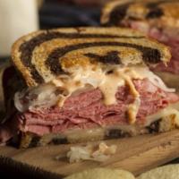 Reuben · Sliced corned beef served on fresh marble rye bread with Swiss cheese, sauerkraut and Russia...