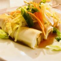 Fresh Spring Rolls · Rice paper wraps stuffed with tofu, cucumber and eggs topped with sweet and sour sauce.