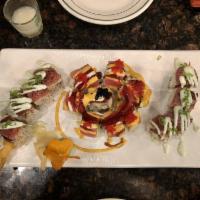 Cherry Blossom · Salmon, avocado, crab meat on the inside and tuna, tobiko on the outside with 3 special sauc...