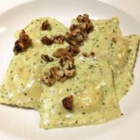 Cheese Ravioli · Five 6-cheese ravioli tossed in a basil-pesto sauce, finished with candied walnuts. Served w...