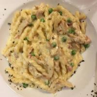 Chicken Carbonara · Tender slices of grilled chicken with pancetta and peas tossed in a Parmesan cream sauce. Se...