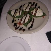 Caprese Bruschetta · Toasted garlic bread topped with sliced tomatoes, house-made mozzarella, fresh basil and bal...