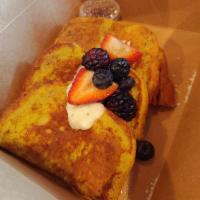 Sourdough French Toast · Classic vanilla cinnamon topped with Chantilly cream, powdered sugar and fresh berries