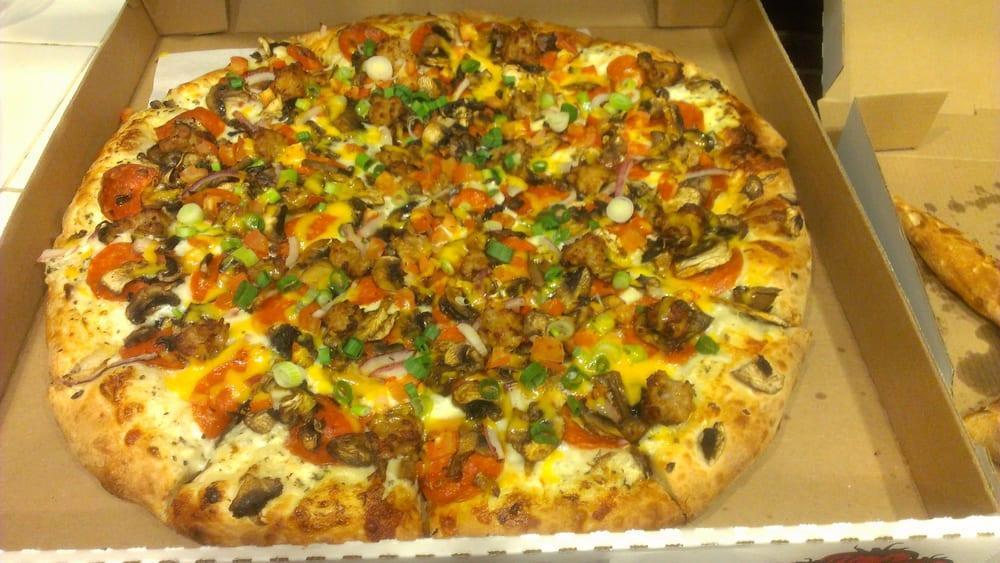 Garlic Gourmet Pizza · Creamy white garlic sauce, mozzarella cheese, pepperoni, mushrooms, red onions, sausage, tomatoes, green onions and cheddar cheese.