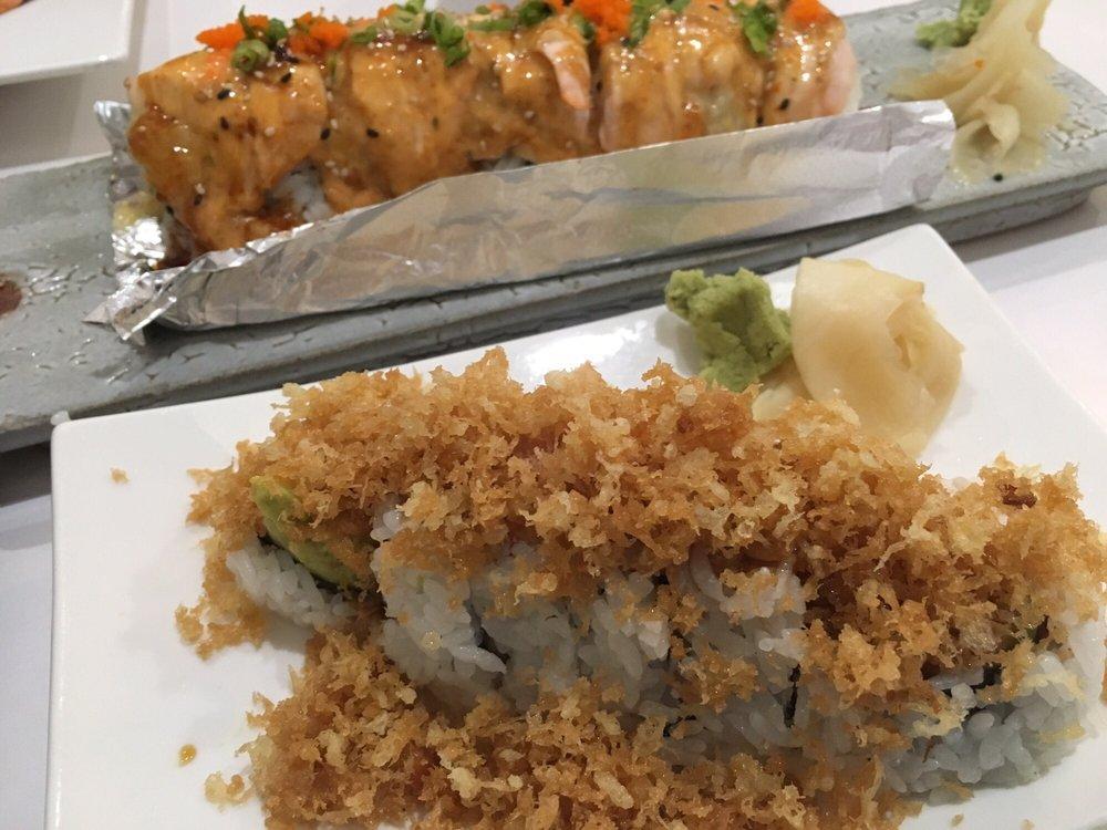 Lion King Roll · California roll topped with a choice of baked salmon or scallop with tobiko & eel sauce.