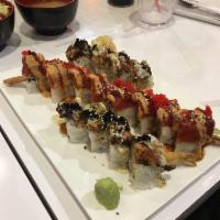Black Dragon Roll · Shrimp tempura, crab meat & cucumber topped with deep-fried eel, tobiko, eel sauce & wasabi ...
