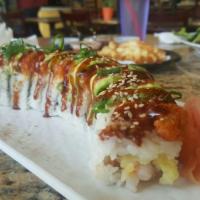 Tiger Roll · Most popular roll! Spicy tuna garnished with avocado & eel sauce atop Shrimp tempura roll wi...