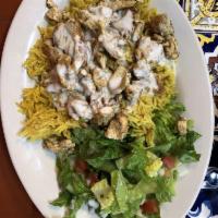 Chicken Shawarma Plate · Turmeric rice topped with grilled chicken shawarma and tahini sauce, served with house salad...