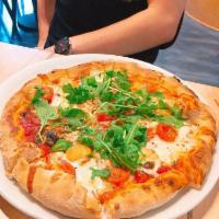 Santa Brigida Pizza · Tomato, fresh mozzarella, cherry tomato, and arugula.
