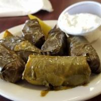 Dolmas · Grape leaves stuffed with rice and spices, served with cucumber sauce.