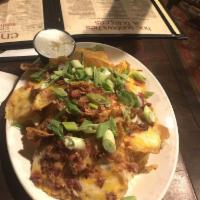 Irish Kettle Chips · Home-made chips topped by crispy Irish bacon, melted Irish cheddar and blue cheese with scal...