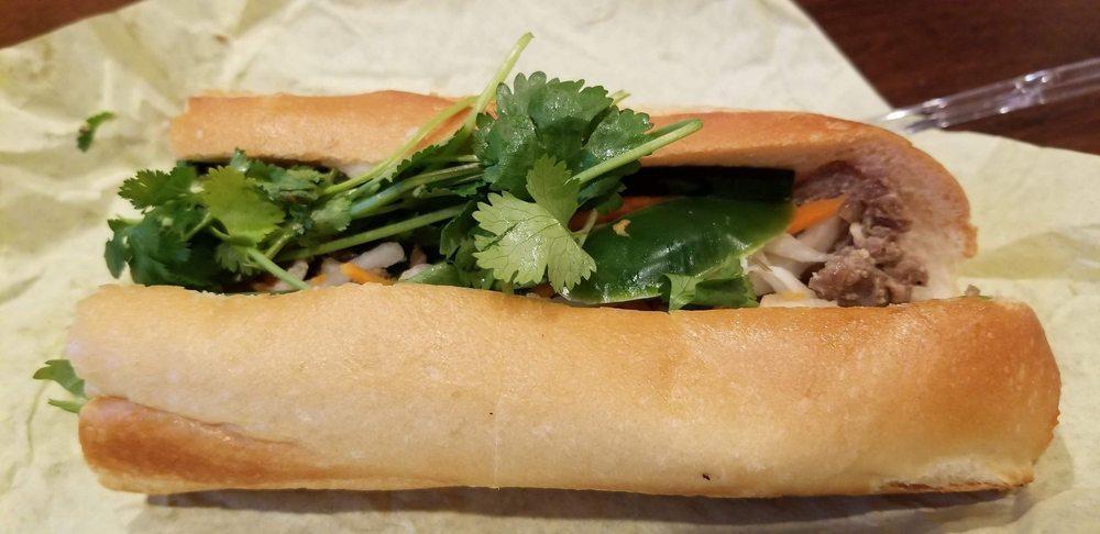 Grilled Pork Sandwich · Foot long sandwich cut in half served with pickled carrot, daikon, radish, cucumber, cilantro, and jalapeno unless requested otherwise.