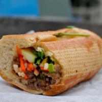 Grilled Beef Sandwich · Foot long sandwich cut in half served with pickled carrot, daikon, radish, cucumber, cilantr...