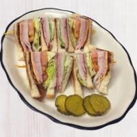 Club Sandwich · Prepared with ham, turkey, bacon, American cheese, mayonnaise, lettuce and tomato on white t...