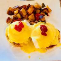 Eggs Benedict · English muffin topped with Canadian bacon, poached eggs with a finishing touch of Hollandais...
