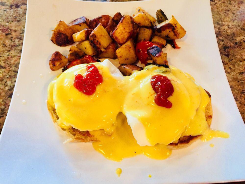 Eggs Benedict · English muffin topped with Canadian bacon, poached eggs with a finishing touch of Hollandaise sauce. Served with choice of side.