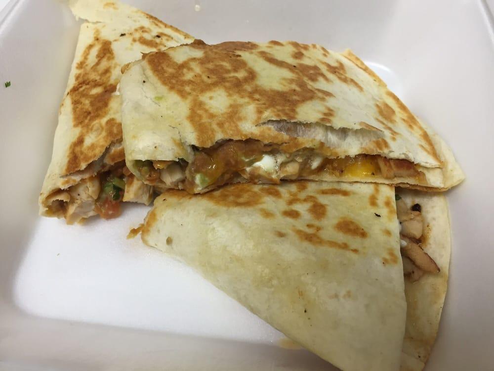 Chicken Quesadilla · Marinated chicken simmered in our own pico de gallo, placed in a flour tortilla with melted cheese, beans, guacamole, sour cream, and pico de gallo.
