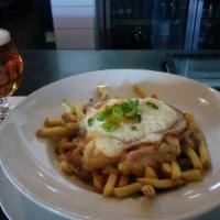 Poutine · Hand Cut Kennebec fries smothered in smoked bacon gravy, burrata mozzarella, and topped with...