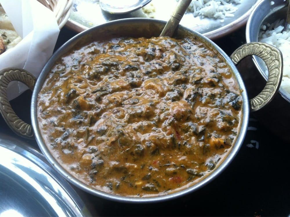 Palak Paneer · Minced spinach with homemade cheese cubes in a light creamy sauce. Gluten free.