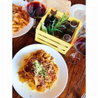 Pappardelle Bolognese · Ribbons of flat egg noodles sauteed in grandma Enza's meat sauce, topped with Parmigiano Reg...