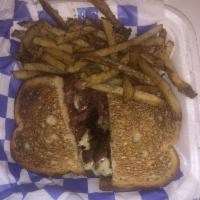 New Yorker Reuben · Lean corned beef, pastrami, sauerkraut and Swiss cheese served hot on toasted rye with Russi...
